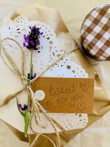 GIFTING SOURDOUGH BREAD - Sourdough bread wrapped in cream linen tea towel and tied with twine and lavender flower.
