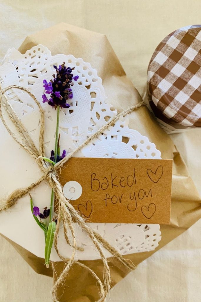 GIFTING SOURDOUGH BREAD - Sourdough bread wrapped in cream linen tea towel and tied with twine and lavender flower.