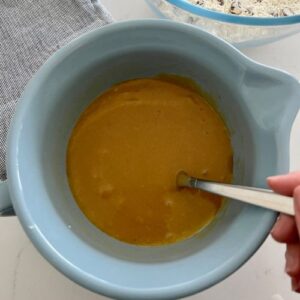 Wet ingredients mixed together in a blue batter jug.