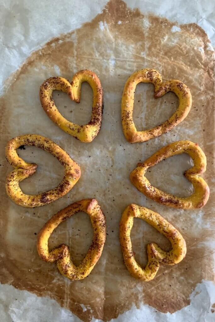 sourdough pumpkin grissini shaped into hearts and sprinkled with sumac before baking
