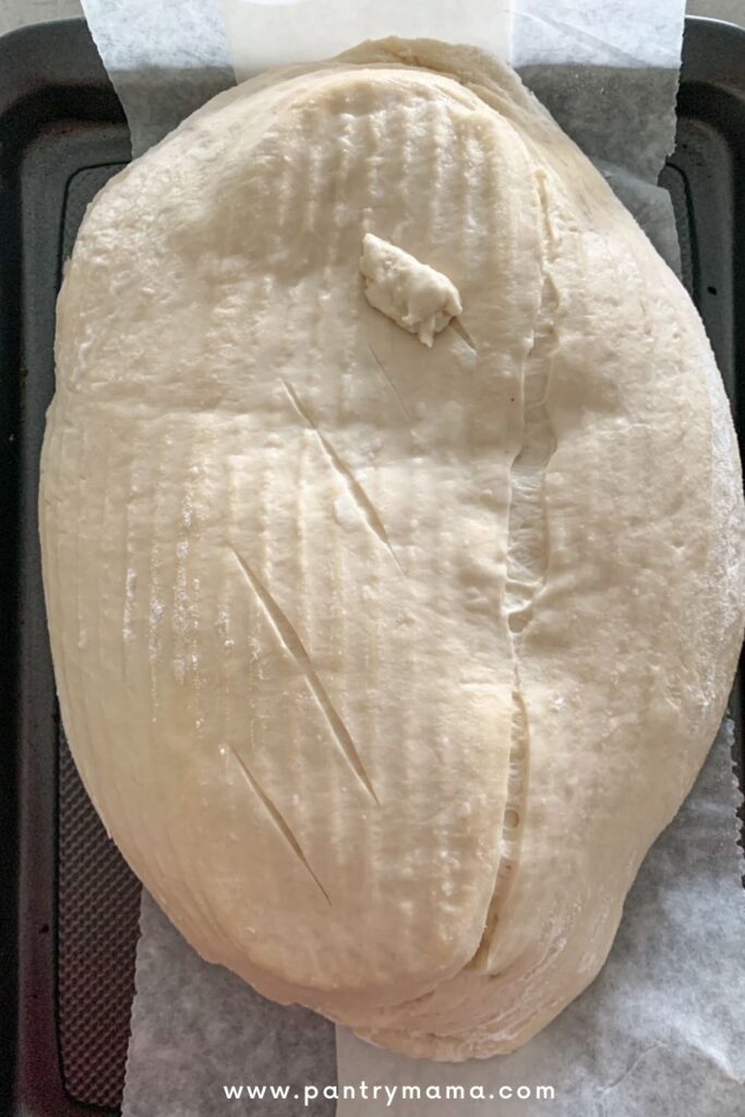 Bread deflates when scored - a common problem with sourdough bread that is over proofed.