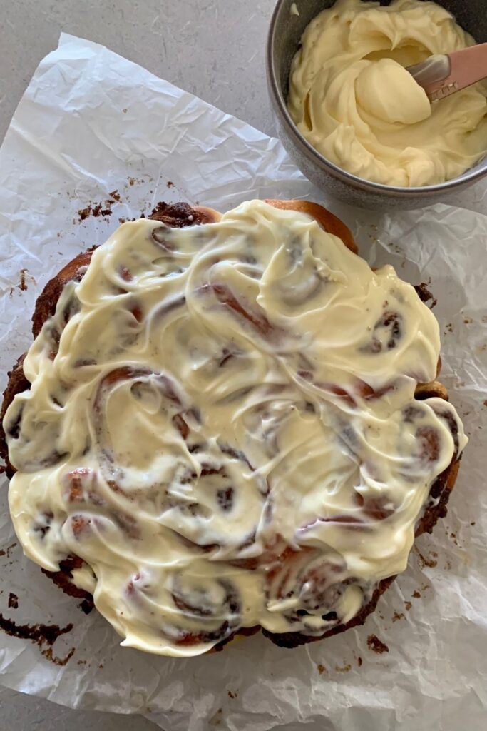 Fluffy sourdough cinnamon rolls smothered in vanilla cream cheese frosting.