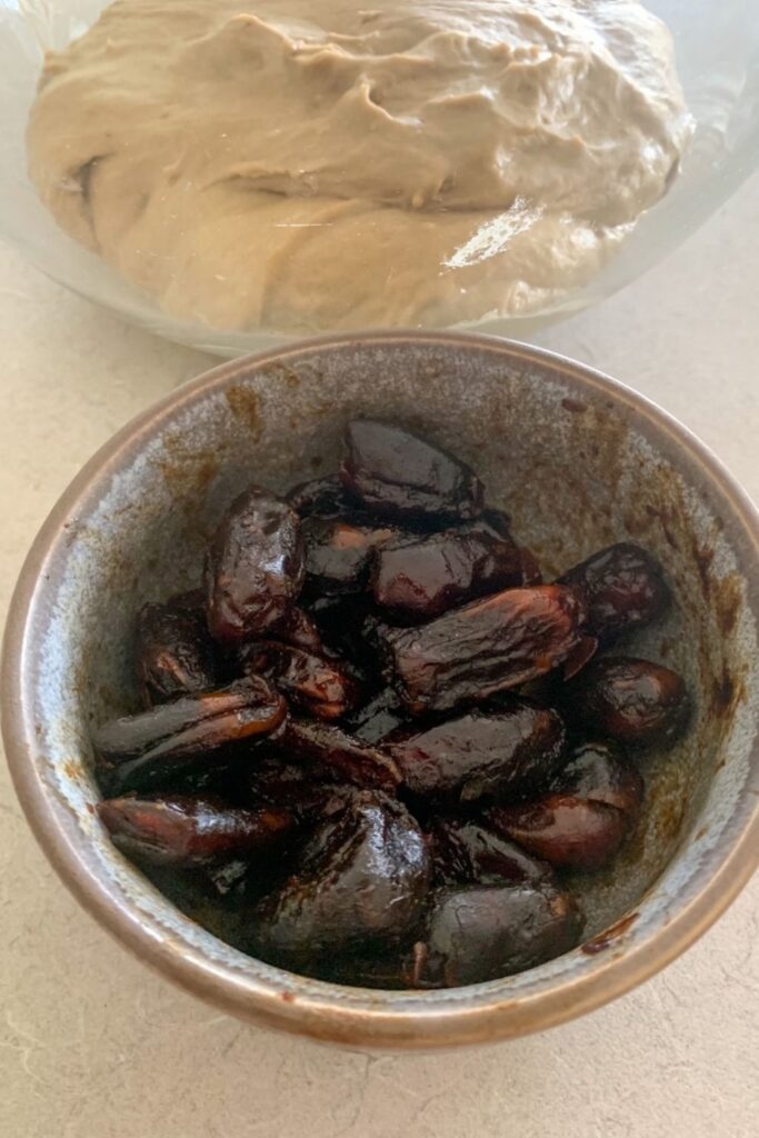 Adding coffee to sourdough - a bowl showing dates being soaked in coffee sitting next to fermenting sourdough