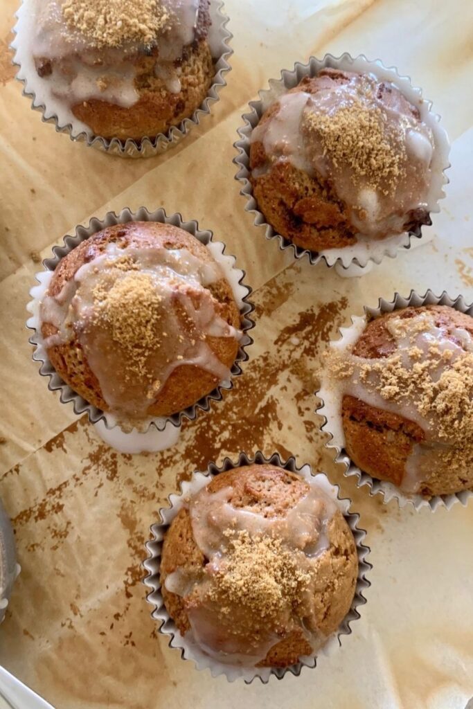 Sourdough Gingerbread Muffins topped with a sugar glaze and gingerbread crumb.