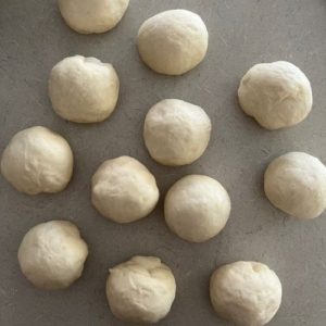Form 80g pieces of sourdough bagel dough into 80g balls.