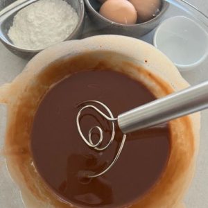 Melted chocolate and butter together in a bowl - whisked using a Danish Whisk