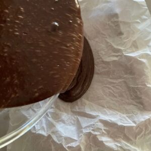 Pouring the batter into a parchment lined tin.