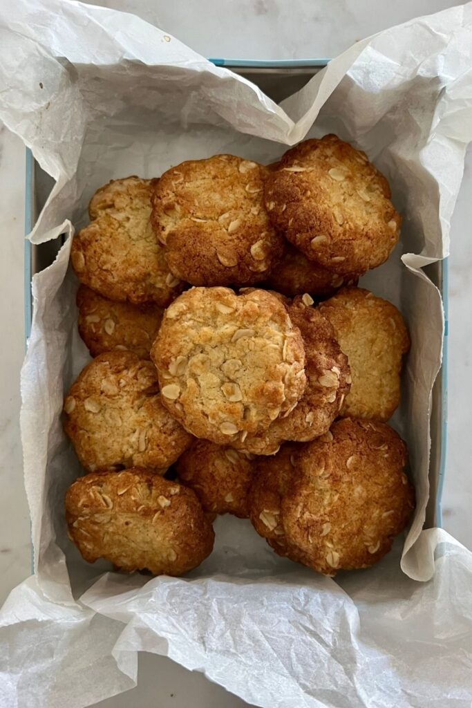 Sourdough Anzac Biscuits presented in a decorative tin