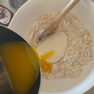 Mixing the sourdough starter and butter mixture into the dry ingredients.