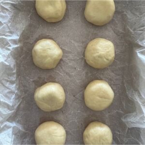 Place donut balls onto a parchment lined tray