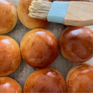 applying butter to sourdough brioche buns