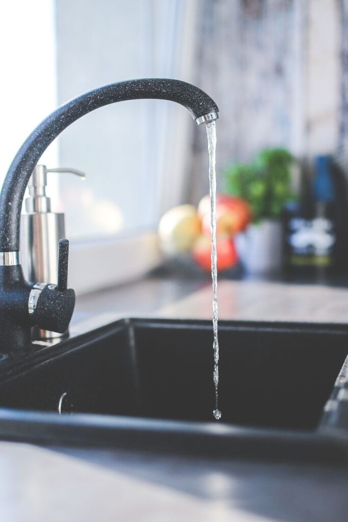 Black kitchen sink with tap running - what water to use for sourdough?