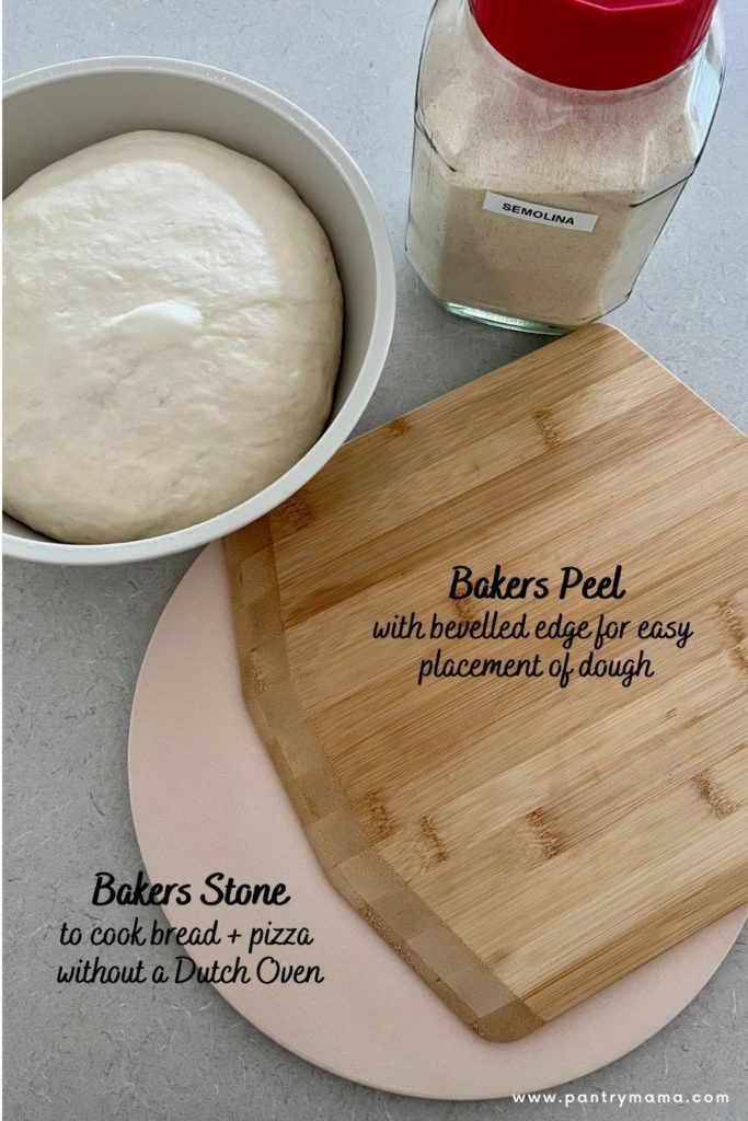 Photo showing bakers peel and pizza stone for baking bread. Banneton basket of dough and jar of semolina also in the photo