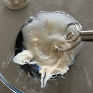 Mix sourdough starter, water and honey together using a Danish Whisk.