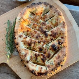 Golden baked sourdough fougasse topped with olive oil, rosemary and salt