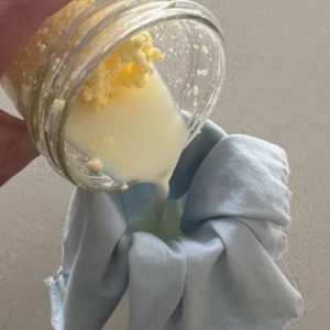 Straining buttermilk through a cloth