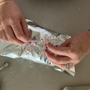 Wrapping sourdough garlic bread in aluminium foil