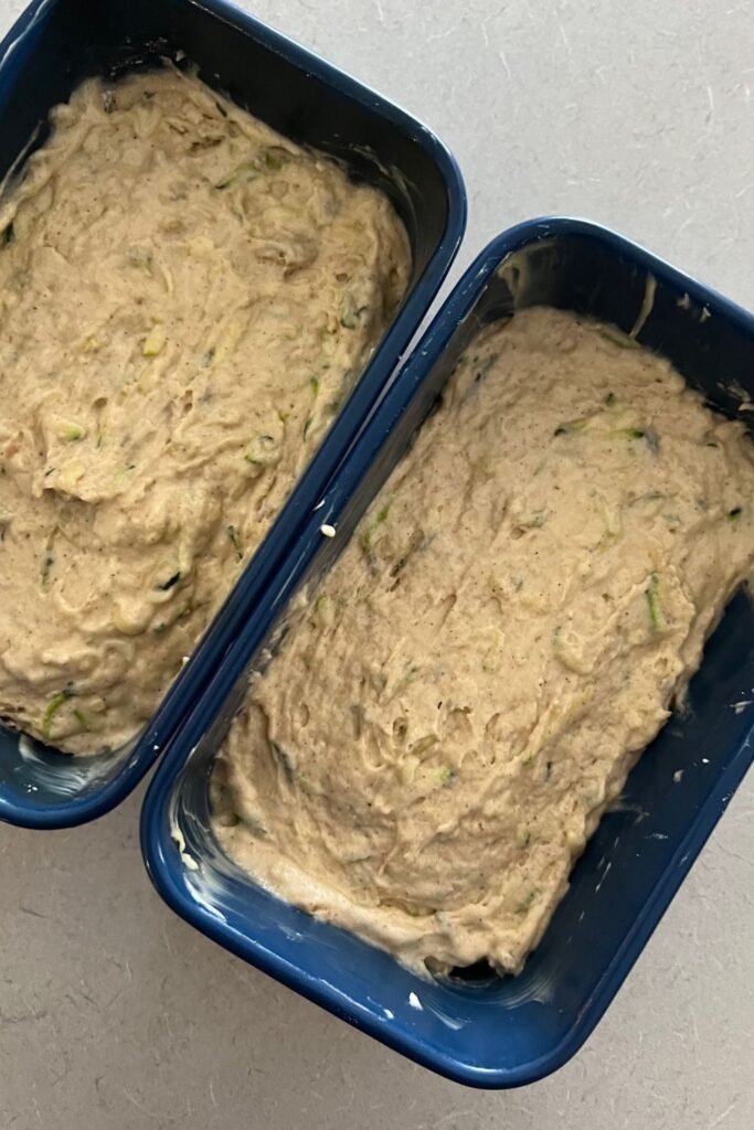 Sourdough zucchini bread - 2 loaf pans filled with sourdough zucchini bread batter