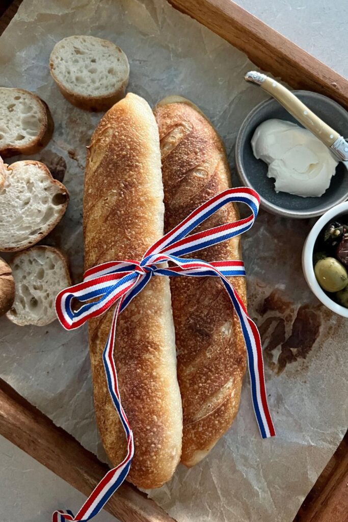 2 sourdough baguettes tied with a red, white and blue ribbon. 