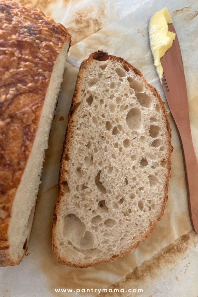 Sourdough secrets for busy moms - slice of sourdough bread alongside a rose gold butter knife.