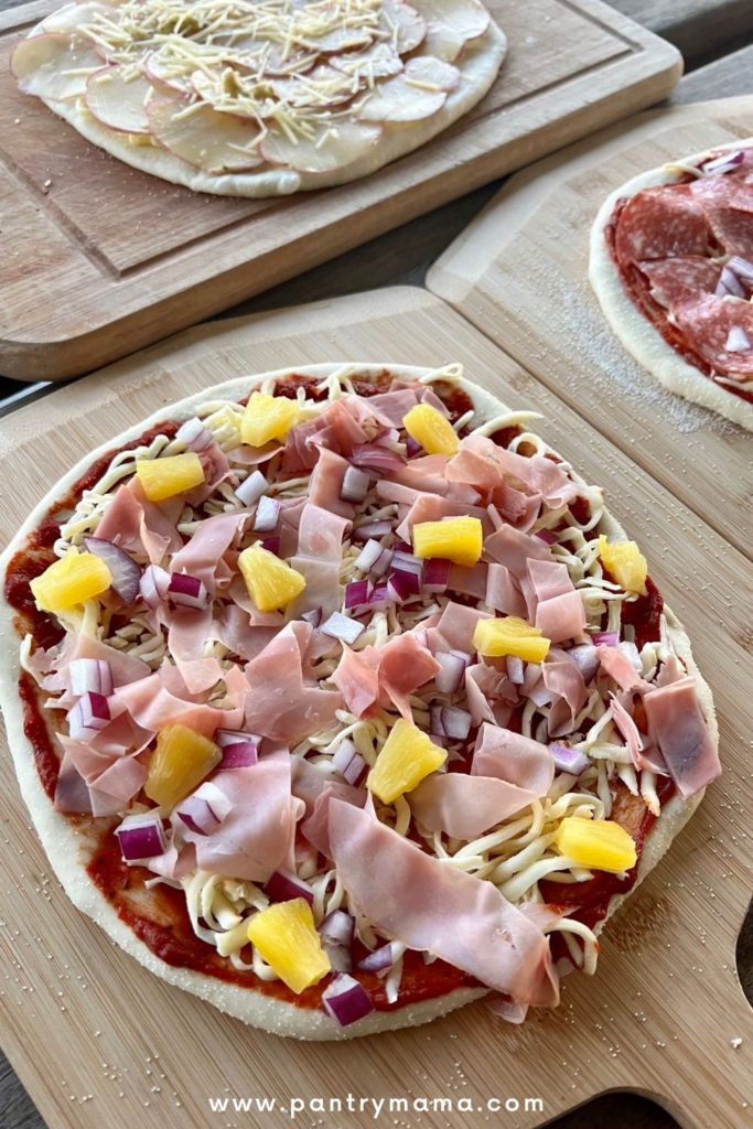 Homemade pizza topped with pineapple and ham
