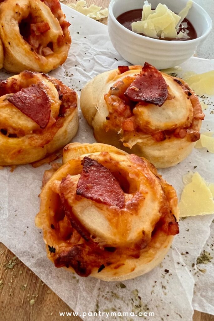 Sourdough pizza rolls topped with pepperoni and served with extra marinara sauce for dipping.