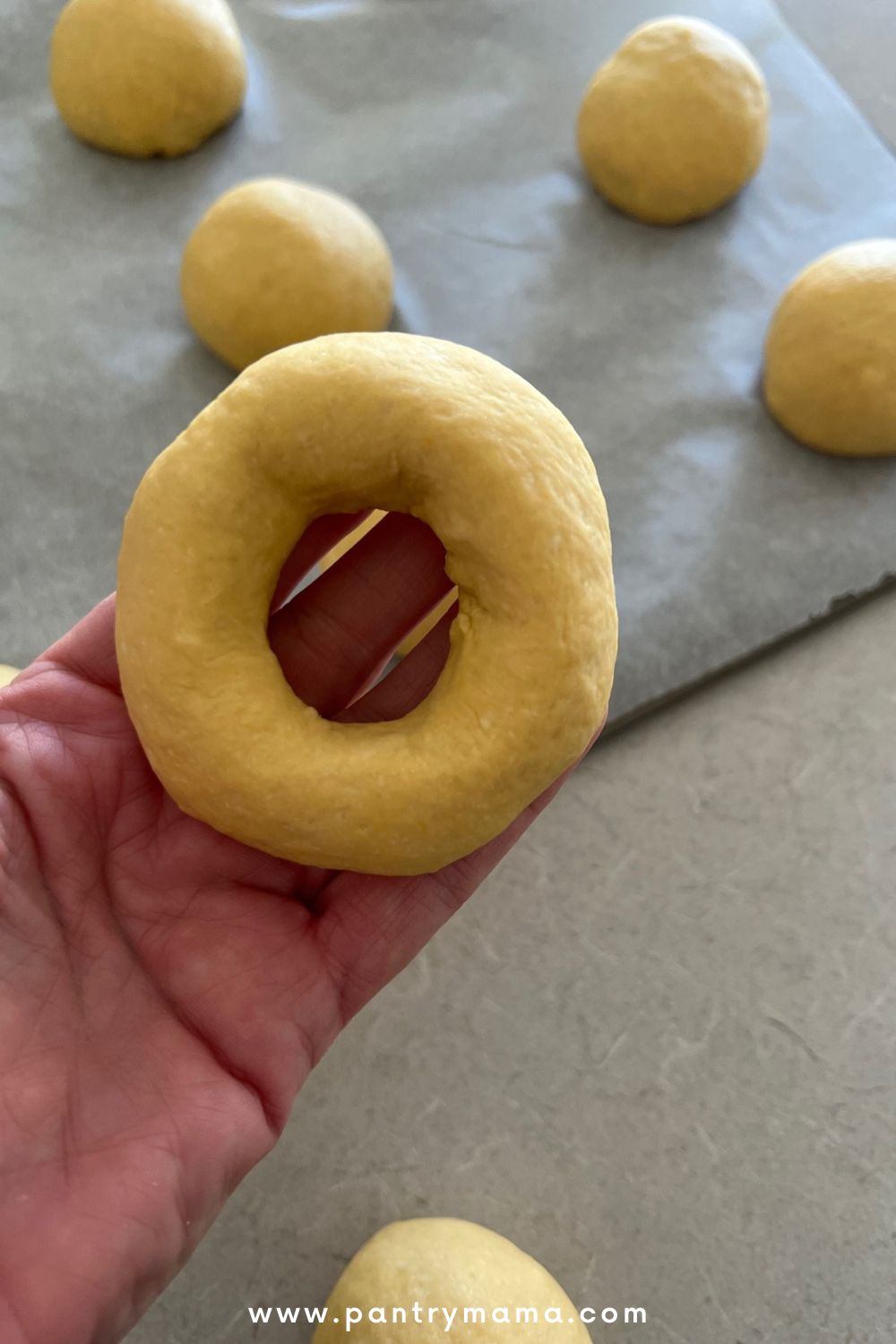 Shaping sourdough pumpkin bagels by hand - always make the hole a bit bigger than you think it should be.