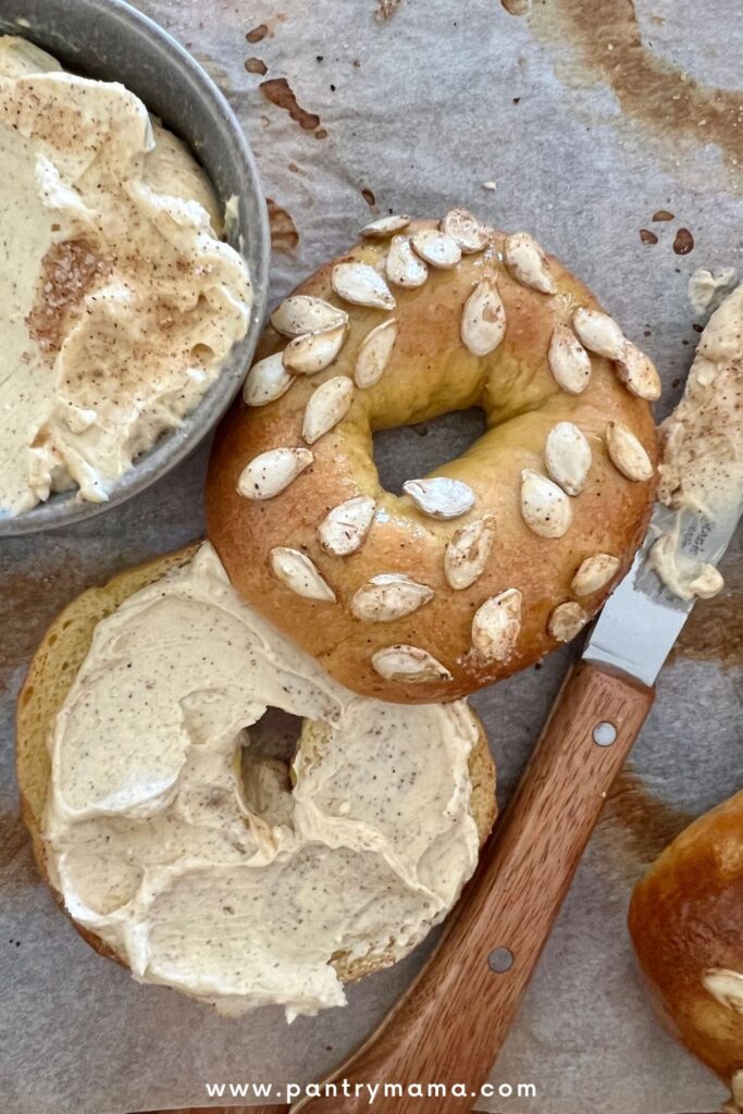 Sourdough Pumpkin Bagel topped with roasted pumpkin seeds and pumpkin cream cheese.