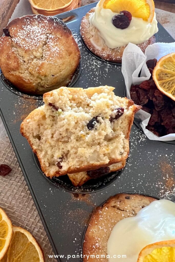 Close up shot of the tender crumb of orange cranberry sourdough muffins.