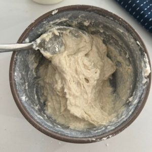Mixing flour and yogurt together to make a yogurt sourdough starter