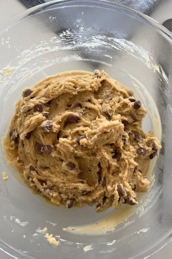 Sourdough chocolate chip cookie dough in a glass bowl. The dough has been in the fridge.
