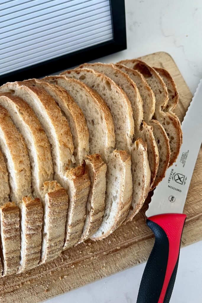 loaf of sourdough bread that has been sliced into even slices using a  Mercer Bread Knife.