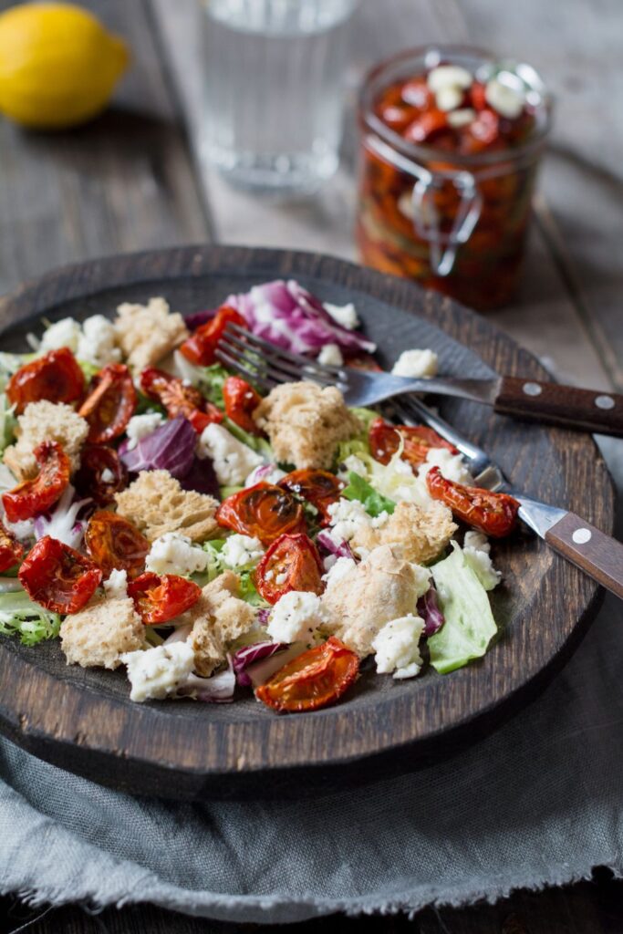 Panzanella Salad or Italian Bread Salad using sourdough bread served on a brown plate.