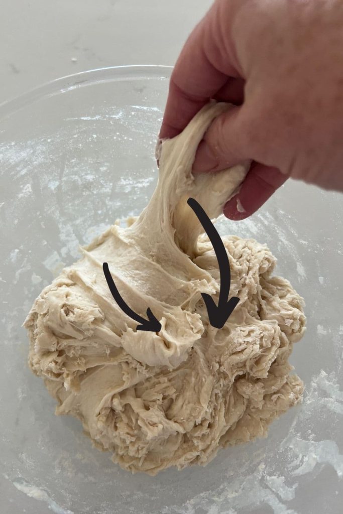 An informational photo showing the direction of the dough being pulled into the centre of the bowl.