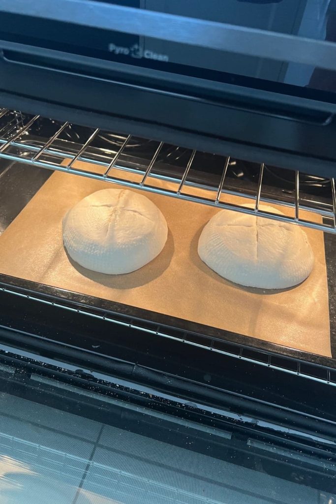 Sourdough bread bowls being baked in the oven as an open bake.