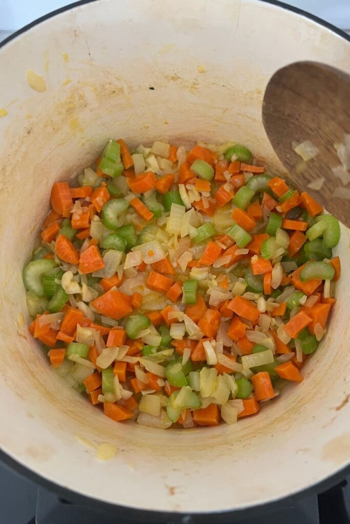 Diced carrot, celery, onion and garlic being sauted in a heavy based pot.