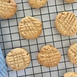 Sourdough Discard Peanut Butter Cookies sitting on a black wire cooling rack.