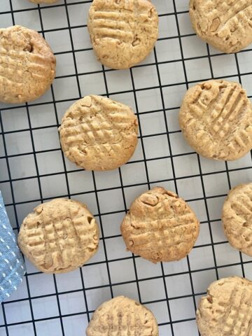 Sourdough Discard Peanut Butter Cookies sitting on a black wire cooling rack.