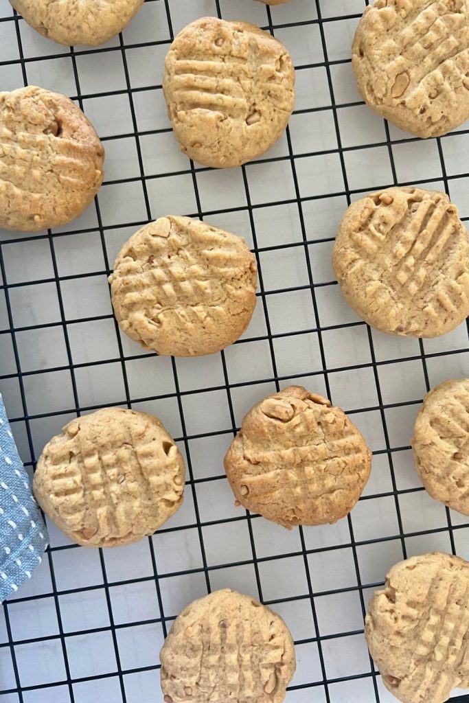 Sourdough Discard Peanut Butter Cookies sitting on a black wire cooling rack.
