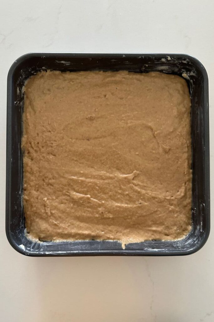 Cake batter spread into the cake pan.