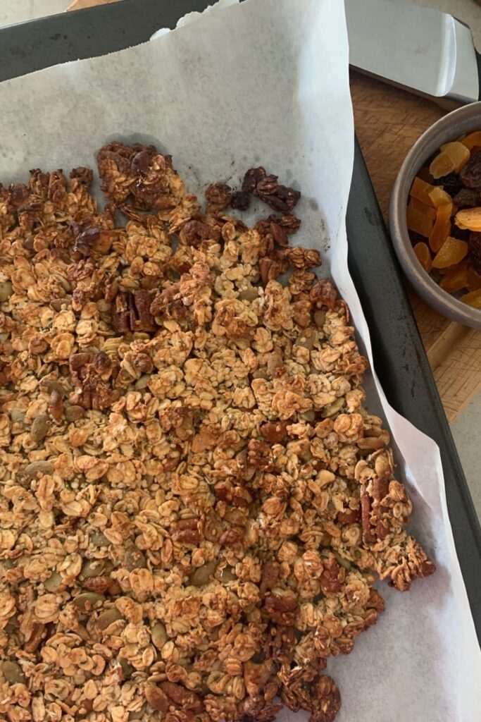 Sourdough granola that has just come out of the oven. It's still in one whole piece and needs to be broken up so it can be used for sourdough snacks.