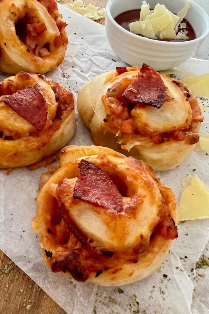 Sourdough pizza rolls topped with triangles of pepperoni.