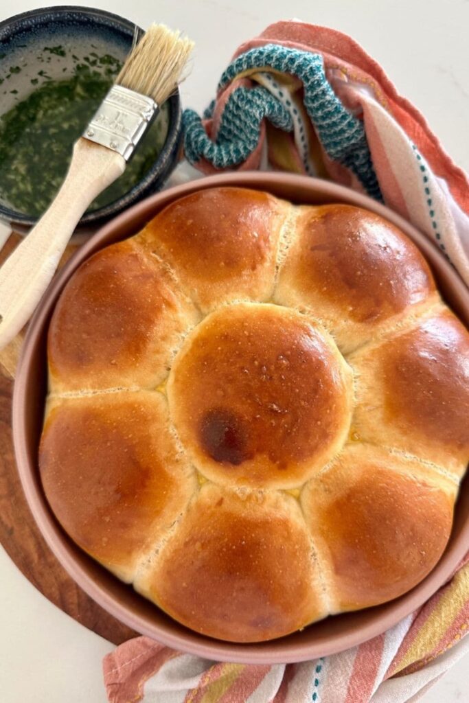 Golden brown sourdough pampushky that have just come out of the oven. They have not yet been covered in herb oil.