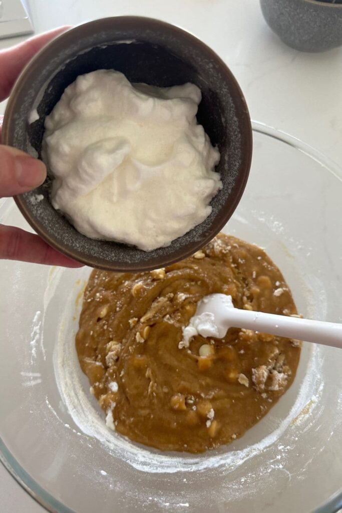 Adding the whipped egg whites to the rest of the sourdough blondie mixture.