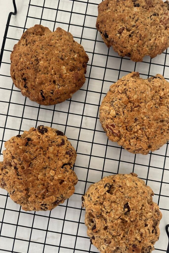 5 sourdough breakfast cookies sitting on a wire cooling rack.