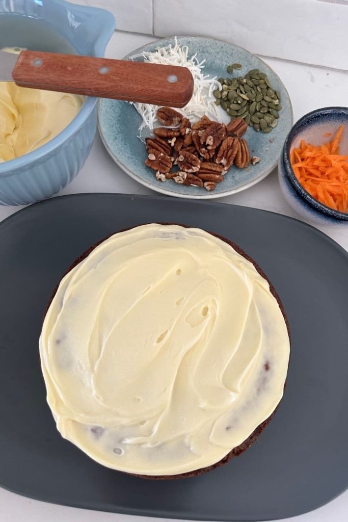 Sourdough carrot cake with icing on the first layer.