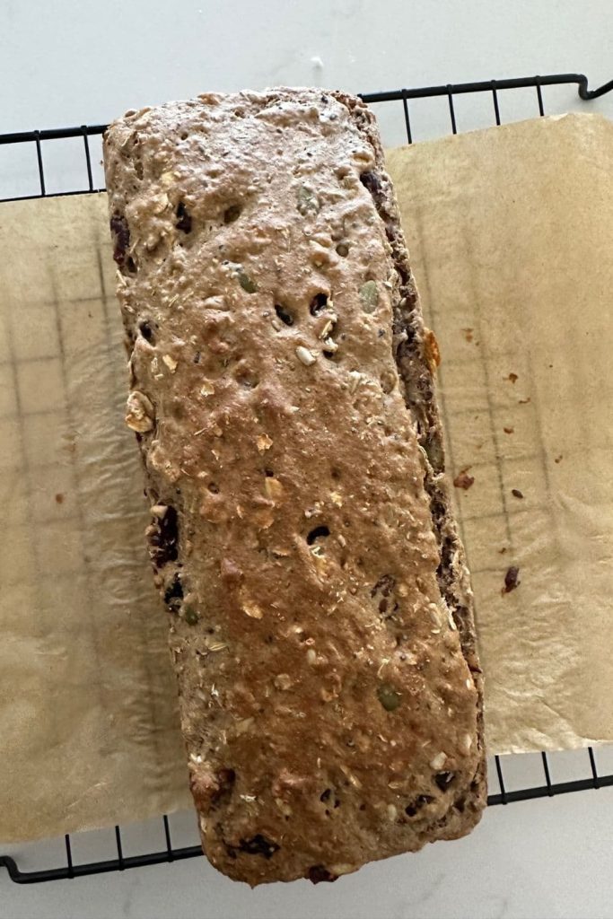 Sourdough fruit and seed cracker log that has been baked once and is ready to freeze before slicing.