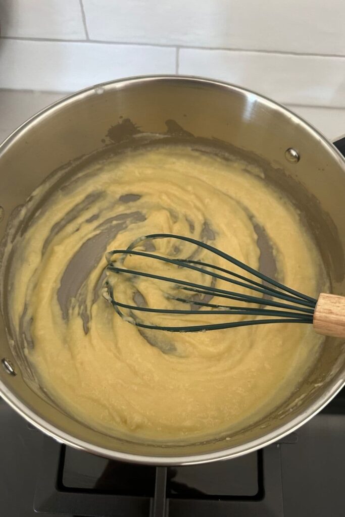 Roux starting to thicken when making sourdough mac and cheese. This is being whisked to stop lumps forming.