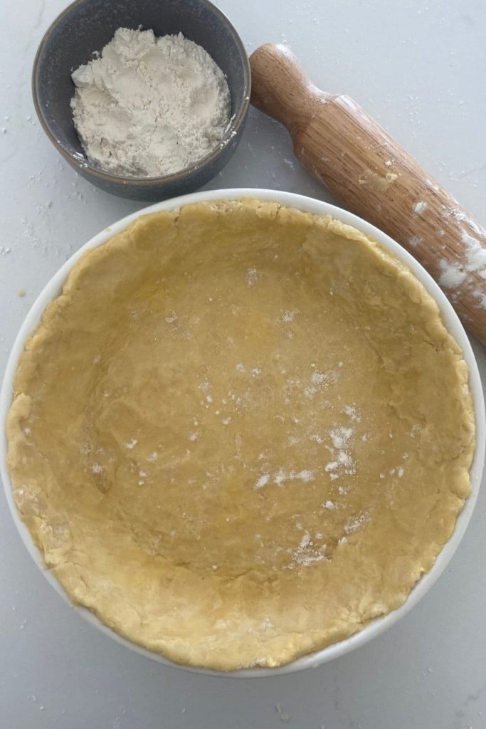 Sourdough pie crust formed into a pie plate.