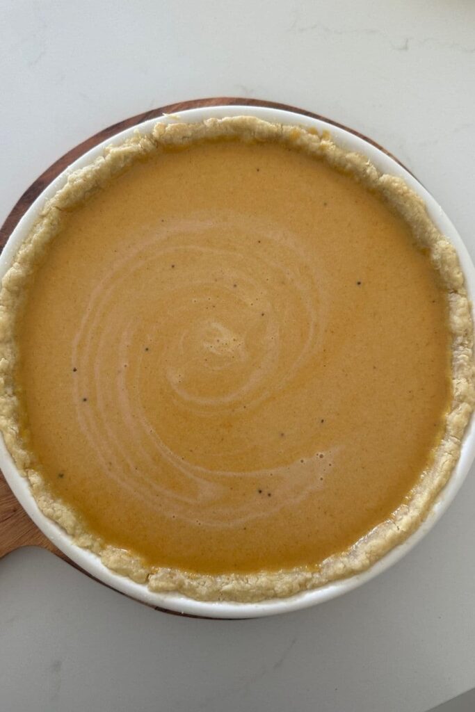 A photograph of an uncooked pumpkin pie.